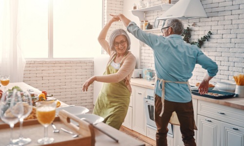 older couple dances in their kitchen
